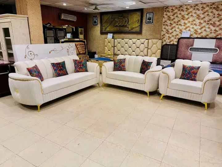 A cream sofa set with gold legs on display